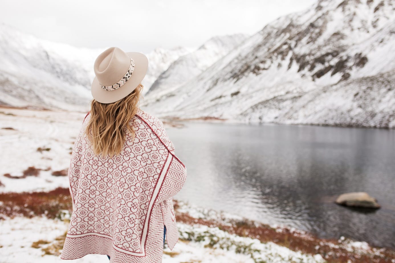 Woman traveler on the background of a beautiful mountain lake